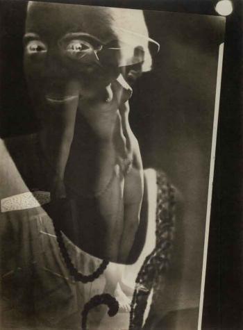 Photomontage, standing nude with superimposed face by 
																	Maurice Tabard