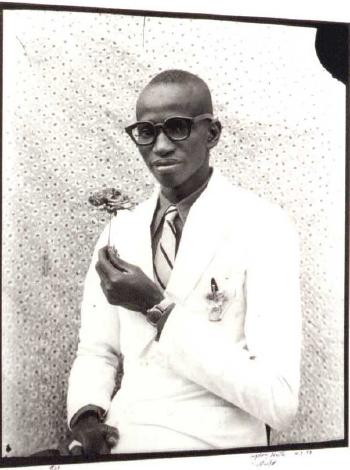Elegant young man holding a flower, 1958 by 
																	Seydou Keita