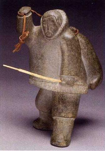 Inuit hunter with seal over his shoulder, carrying a harpoon by 
																	Jimmy Kakayak