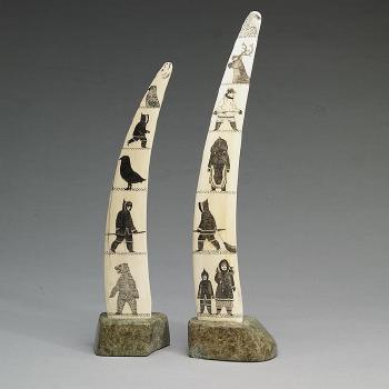 Pair of incised tusks on bases by 
																	Davidee Itulu