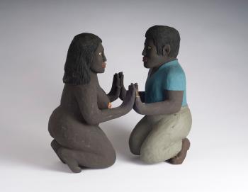 Kneeling figures of a black man and woman by 
																	Saturnino Portuondo Odio