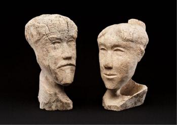 Heads of a man and a woman by 
																			Pauloosie Kakee