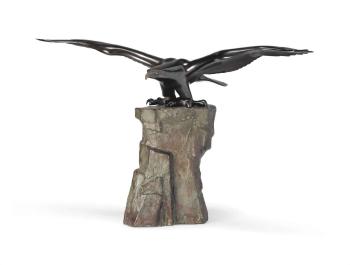 A cast bronze model of an eagle taking off from a tall rock by 
																	Masahiko Katori