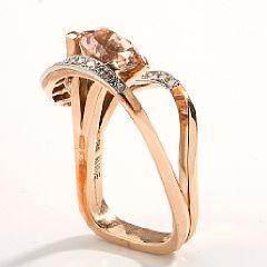 A morganite and diamond ring set with a circular-cut morganite by 
																			Jytte Klove