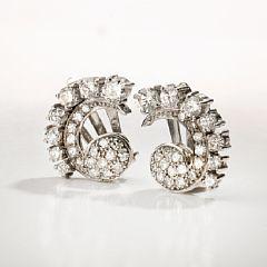 A pair of diamond ear clips by 
																			Willy Junget