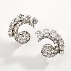 A pair of diamond ear clips by 
																			Willy Junget