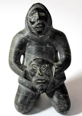 Man holding Spirit Face by 
																			Pauloosie Enuaraq