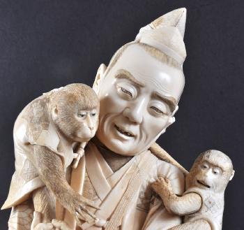 A Monkey trainer wearing ornate robes, with Monkeys seated upon his shoulder with one in a hanging basket by his side by 
																			Shunmitsusen Gyokusho
