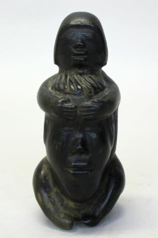 Male figure holding a spirit face by 
																			Aggiuq Takunaraq