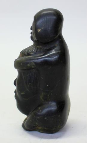 Male figure holding a spirit face by 
																			Aggiuq Takunaraq