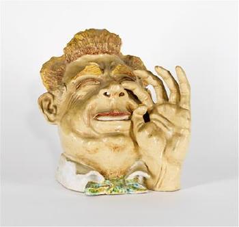 Maske eines lachenden Herren mit seiner linken Hand by 
																	Franz Dworschak