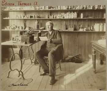 A seated portrait of Edison in his laboratory by 
																	C C Langill