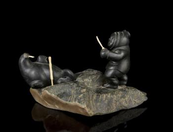 Carving of a hunter and walrus by 
																			Moses Aupaluktuk
