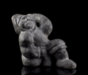 Carving of a kneeling figure by 
																			Paul Toolooktook