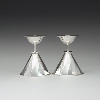 A pair of candlesticks by 
																			Carl Nystromer