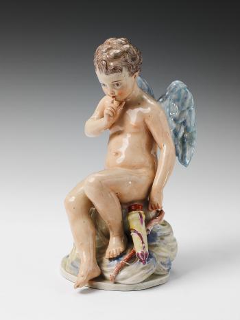 A figure of Cupid seated by 
																	Joseph Hannong
