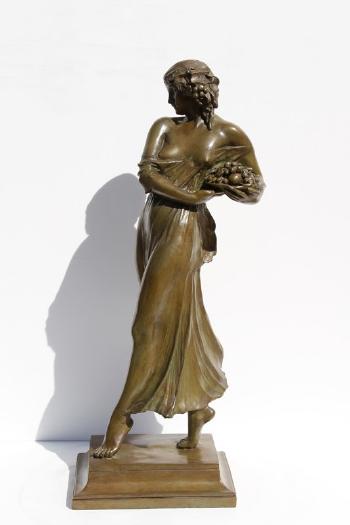 Woman carrying grapes by 
																			Mario Joseph Korbel