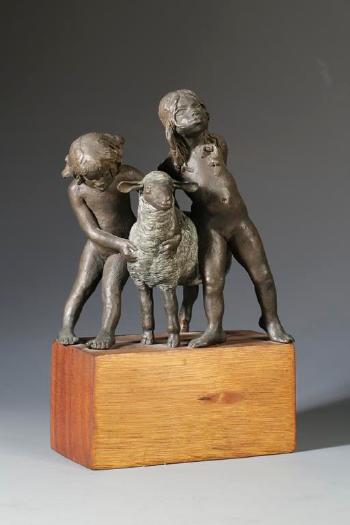 A sculpture of two young children and a sheep by 
																	John Uht