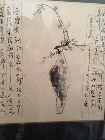 Vase contenant une branche de prunus fleurie, cadré de deux calligraphies by 
																	 Fang Jiekan