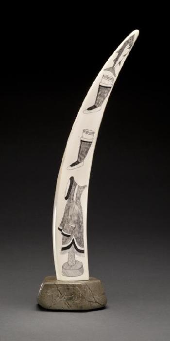 Engraved tusk on a base by 
																			Innuki Oqutaq