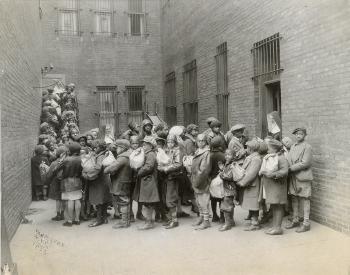 Children in courtyard with nuns by 
																	James Vanderzee