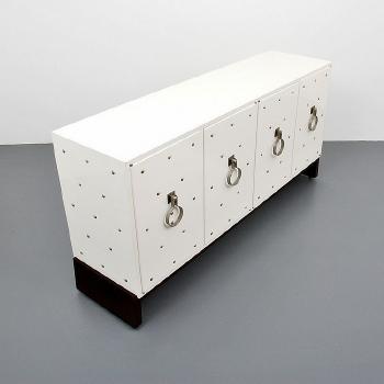 Silver studded cabinet by 
																			Tommi Parzinger