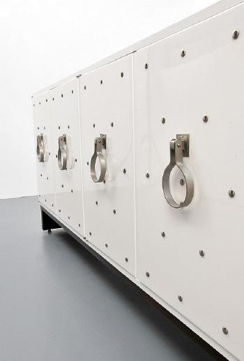 Silver studded cabinet by 
																			Tommi Parzinger