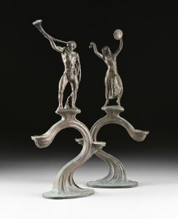 A pair of art nouveau bronze two-light candelabra by 
																			Benno Elkan
