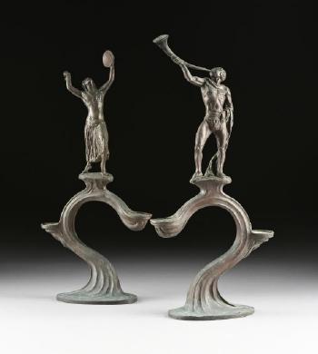 A pair of art nouveau bronze two-light candelabra by 
																			Benno Elkan