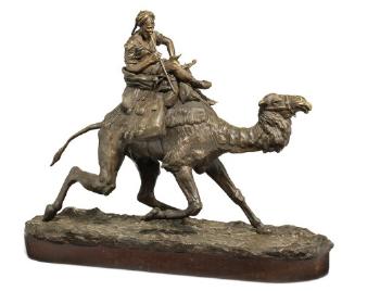 A Russian gilt and patinated bronze sculpture formed as an Arab riding a dromedary by 
																	Piotr Alexandrovich Samonov