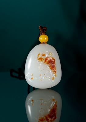 A white jade pendant with landscape pattern by 
																	 Qu Lijun