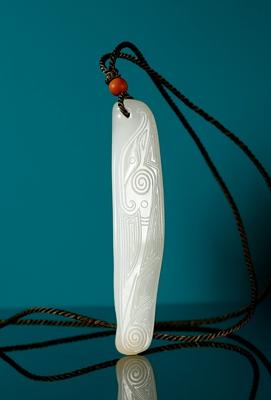 A white jade beast pendant by 
																	 Qu Lijun