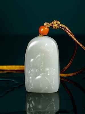 A white jade plaque with three-goat pattern by 
																	 Guo Wanlong