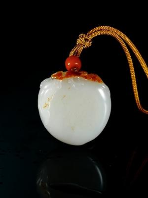 A white jade peach and bat pendant by 
																	 Guo Wanlong