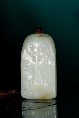 A white jade plaque with dragon and cloud pattern by 
																	 Guo Wanlong