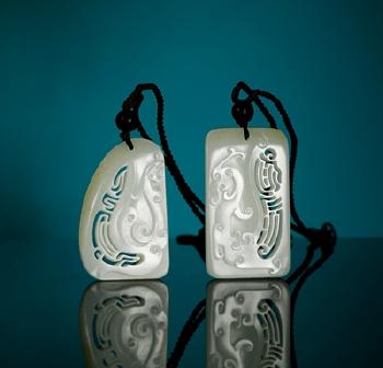 A pair of white jade plaques with dragon and phoenix pattern by 
																	 Yang Xi