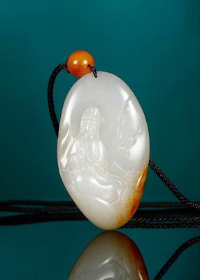 A white jade Guan Yin pendant by 
																	 Zhao Qi