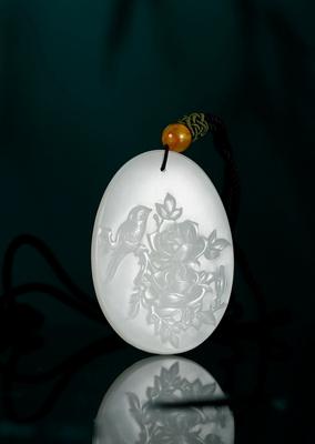 A white jade myna pendant by 
																	 Wu Zaofa