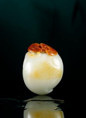 A white jade ornament with bat and peach pattern by 
																	 Wu Zaofa