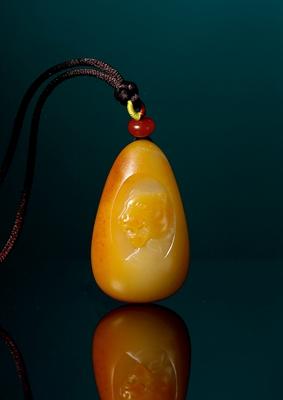 A white jade pendant with tiger pattern by 
																	 Wang Jinzhong