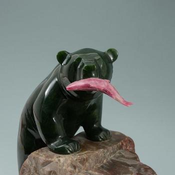 Figure of a bear with pink jade salmon in its mouth by 
																			Lyle Sopel