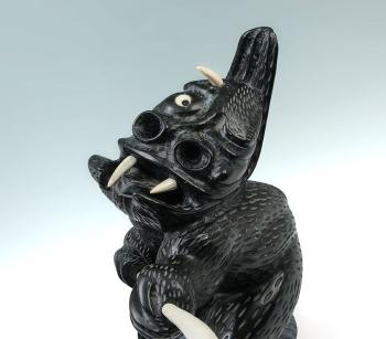 Grotesque carved figure of an Inuit deity by 
																			Charlie Ugyuk
