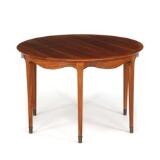 Circular nutwood coffee table with curvy rail, tapering legs mounted with brass by 
																			William Watting