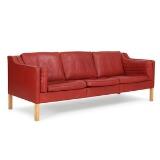 Freestanding three seater sofa with legs of oak, Seat, sides and back upholstered with red coloured leather by 
																			 Fredericia