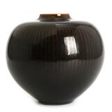 A Royal Copenhagen stoneware vase with broad shoulders, decorated in dark brown glaze with line pattern by 
																			Gerd Bogelund