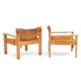 A pair of solid pine easy chairs by 
																			Karin Mobring