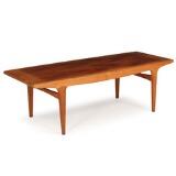 Rectangular coffee table of teak with curved rail by 
																			Johannes Andersen