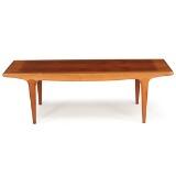 Rectangular coffee table of teak with curved rail by 
																			Johannes Andersen