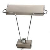 An adjustable chromium-plated and greylacquered metal desk lamp. by 
																			 Jumo