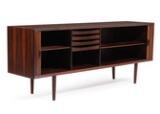 A rosewood sideboard, front with two sliding doors, mahogany interior with shelves and trays by 
																			 Faarup Mobelfabrik